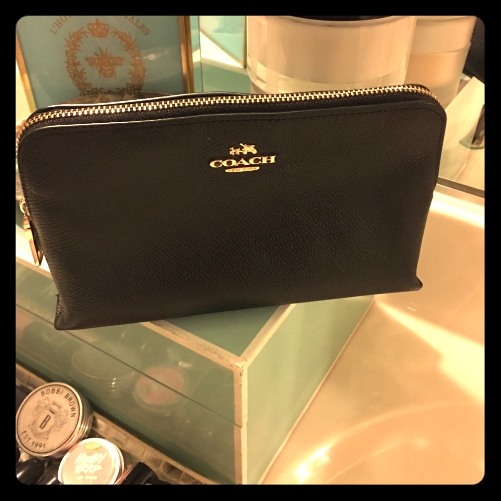 Black, leather coach clutch or makeup bag.